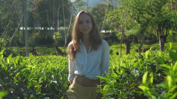 Woman Walks Among Tea Plantation on Sunny Day Slow Motion