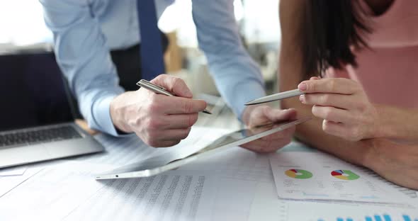 Business Team Leader Shows Diagram on Tablet to Colleague