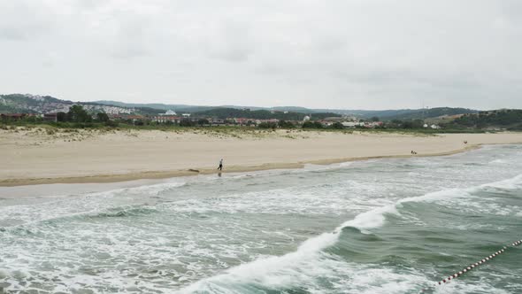 Man Walking On The Beach Aerial View