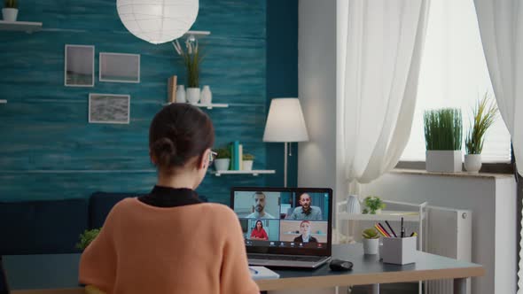 Young Adult Using Online Teleconference on Laptop to Attend Online Class