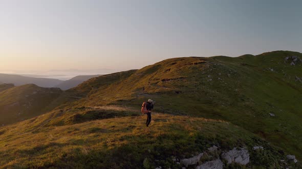 Epic Drone Shot of Photographer on Hike at Sunrise