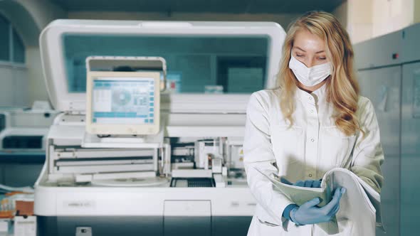 Portrait of a Lab Worker with a Research Folder in Her Hands. Ladorant Reviews Research Records in