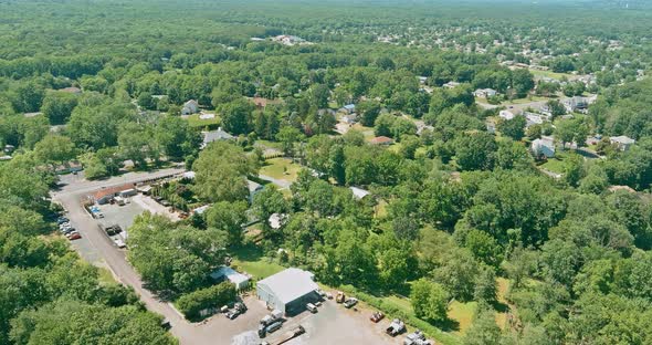 Flight with a Drone Over a with Low Houses in Monroe Town on a Sunny Day in New Jersey USA