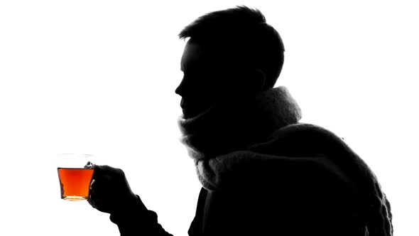 Young Man in Wool Scarf Coughing and Drinking Tea, Winter Influenza, Health