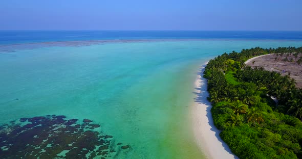 Daytime birds eye abstract shot of a paradise sunny white sand beach and aqua blue water background 