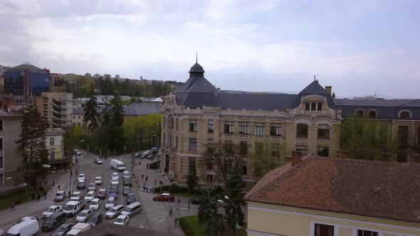 Aerial Tilting Shot of Downtown Cluj Napoca, Romania Revealing Traffic on the Roadway.