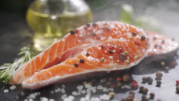 Salmon Fillet Red Fish with Pepper Salt and Rosemary on a Stone Board