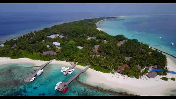 Aerial seascape of tranquil island beach break by aqua blue ocean and bright sand background of jour