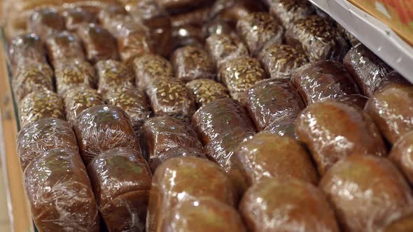 Fresh Black Bread in Cling Film in the Supermarket Closeup