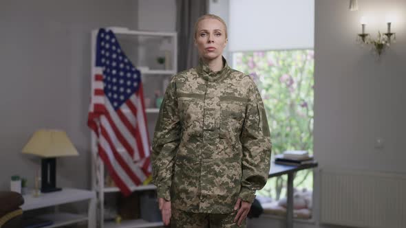 Medium Shot Portrait of Serious Confident Female Recruit Saluting in Slow Motion Looking at Camera