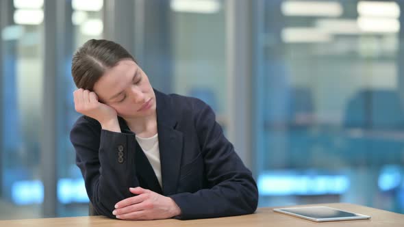 Sleepy Young Businesswoman Taking Nap at Work