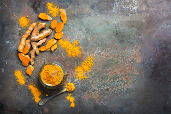 t. Organic orange turmeric root and powder, curcuma longa on a grunge cooking table. Indian oriental low cholesterol spices. Copy space background