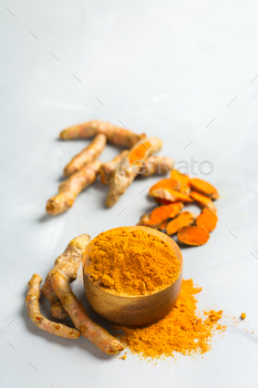 t. Organic orange turmeric root and powder, curcuma longa on a cooking table. Indian oriental low cholesterol spices. Copy space background