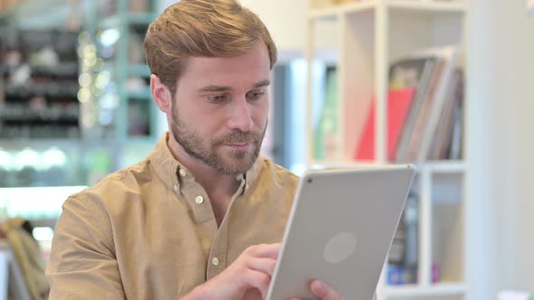 Portrait of Young Man Using Digital Tablet