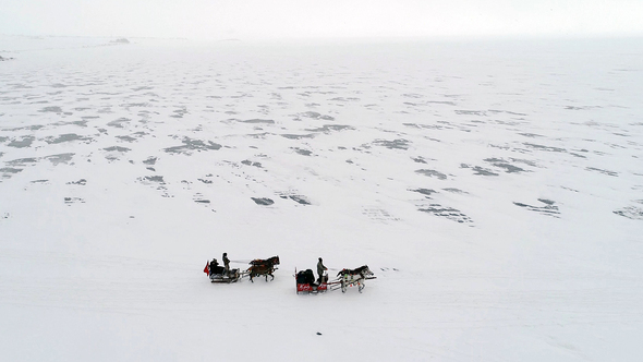 Aerial Top View of Frozen Lake and Sleighs