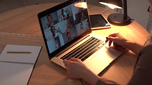 Woman Having Video Chat with Colleagues at Laptop in Office Closeup