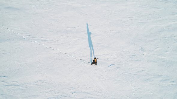 Man Walking on Frozen Lake