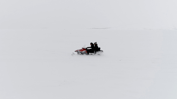 Snowmobile Trip on a Frozen Lake