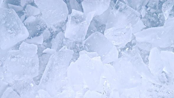 Super Slow Motion Shot of Falling and Shattering Crushed Ice on Light Background at 1000Fps