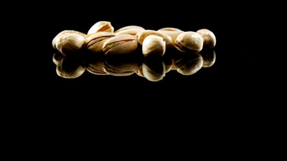 Pistachios falling on black background 4k