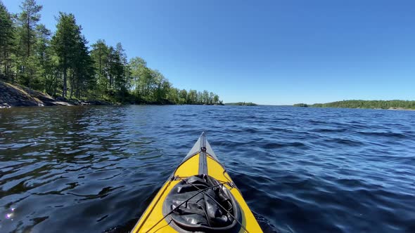 Sports Kayak Sails Along Tranquil Lake Water Past Island