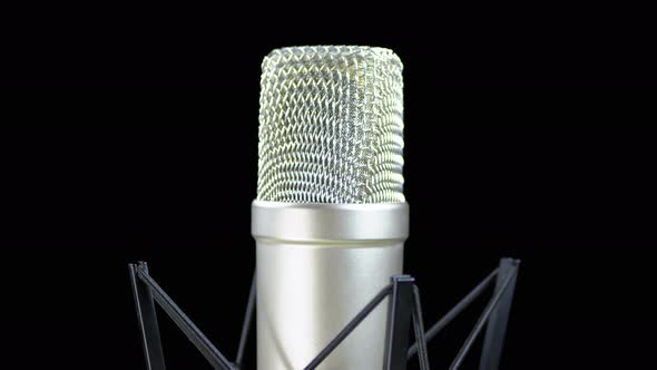 Studio Microphone with Spider Rotates on a Black Background