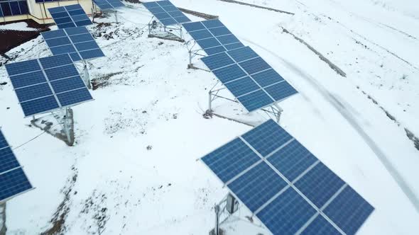 Rows of Snow Covered Solar Panels