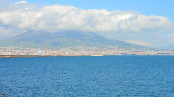 Shot of Naples skyline, port and Vesuvius volcano view in Naples, Italy on a sunny day.