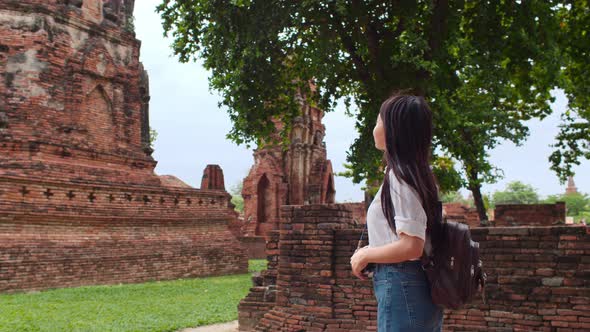 Japanese backpacker female enjoy her journey at amazing landmark in traditional city.