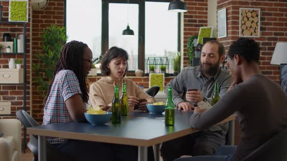 Diverse Group of Friends Playing Cards at Fun Gathering