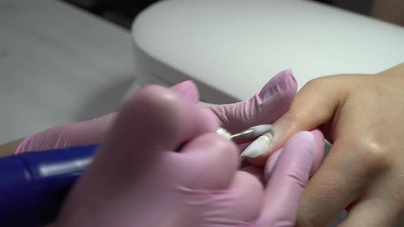 Young Woman in the Salon Does a Manicure