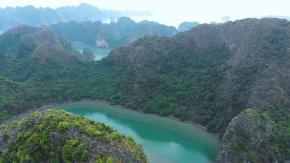 Aerial top down: flying over Ha Long Bay rock pinnacles, famous travel destination in Vietnam