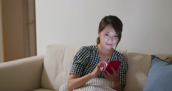 Woman use of smart phone at home in the evening