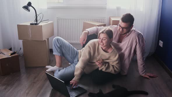 Happy Couple Relaxes After Moving in a New Home