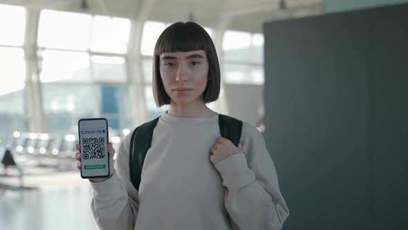 Woman Showing International Certificate of Vaccination