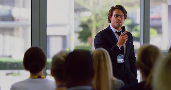 male speaker speaks in a business seminar at modern office 4k