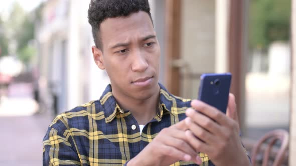 Young African Man Using Smartphone, Outdoor