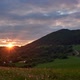 Sunset Over the Hills on a Green Meadow at Countryside in Summer  FHD Timelapse - VideoHive Item for Sale