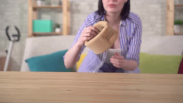 Young Woman with a Sore Neck Puts a Collar Around Her Neck