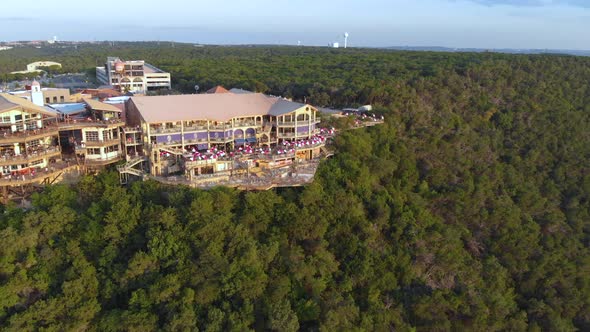 Backwards aerial pan of the restaurants in the oasis on lake travis.  Shot in Austin, TX on 9/10/20