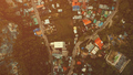 Top down aerial cityscape with lodges, homes, buildings roofs and roads at green tropic forest - PhotoDune Item for Sale