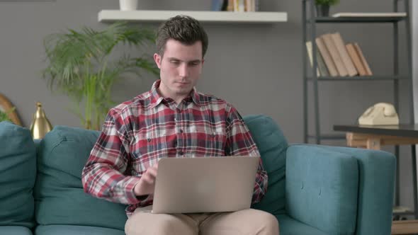 Man Closing Laptop Leaving Sofa