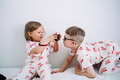 Two children in matching outfits playing with camera. - PhotoDune Item for Sale