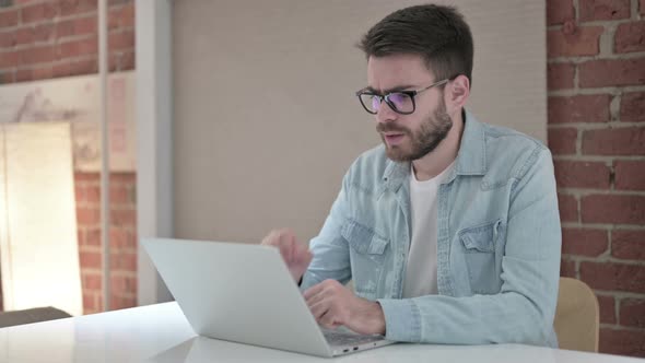 Sick Male Designer Working on Laptop and Coughing 