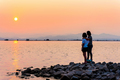 Mother and daughter watching the sunset on the waterfront - PhotoDune Item for Sale