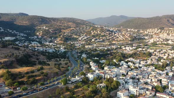 aerial drone flying backwards revealing cars in traffic going to the city of Bodrum in Mugla Turkey