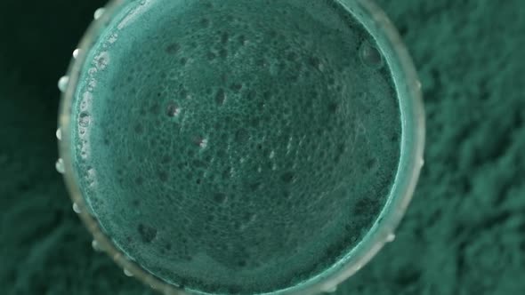 Glass of milk with spirulina powder view from the top