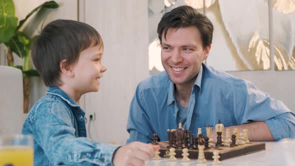 Father and Son Playing Chess