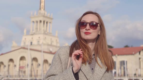 Lovely Woman Posing in Port in Sunny Day.