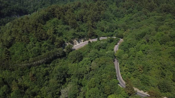 Aerial View From Above of Curve Road with a Car on the Mountain with Green Forest in Russia